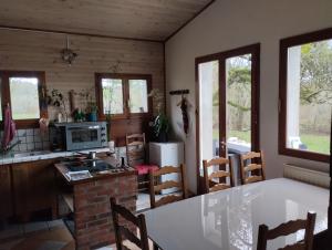a kitchen and dining room with a table and chairs at Le relais Poyo in Arquian