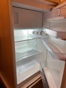 an empty refrigerator with its door open at Very nice, Central and fully Furnished Apartment in Bonn