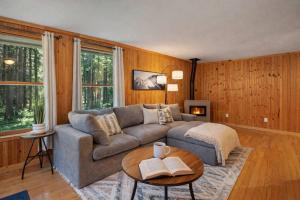 a living room with a couch and a table at Shanty Creek, Golf, Families, Vacation, Pool Pass in Bellaire