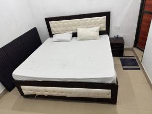a bedroom with a large bed with a white mattress at HOTEL INDRANEEL Hanuman Garhi in Ayodhya
