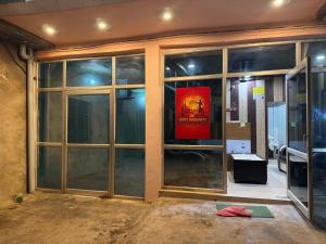 a room with large glass windows in a building at HOTEL INDRANEEL Hanuman Garhi in Ayodhya