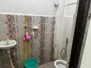 a small bathroom with a sink and a toilet at HOTEL INDRANEEL Hanuman Garhi in Ayodhya +18 photos