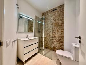 a bathroom with a sink and a glass shower at CASA EN EL CENTRO DE CALELLA A 300 m DE LA PLAYA in Calella +11 photos