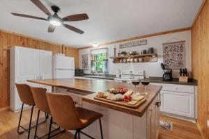 a kitchen with a table with a plate of food and wine glasses at Shanty Creek, Golf, Families, Vacation, Pool Pass in Bellaire