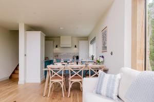 a kitchen and dining room with a table and chairs at The Tractor Shed in Combrook