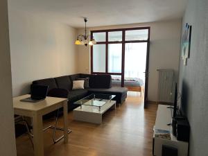 a living room with a couch and a table at Very nice, Central and fully Furnished Apartment in Bonn