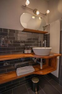 a bathroom with a sink and a mirror at Hotel B&B Stossplatz anytime and easy self Check-in in Appenzell +36 photos