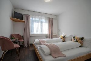a living room with a couch and a window at Hotel B&B Stossplatz anytime and easy self Check-in in Appenzell
