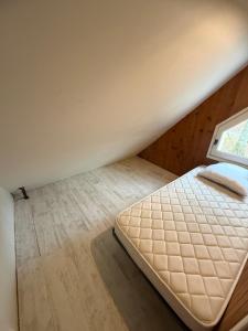 a bed in a room with a window at LK gîte la forêt in Chénérailles