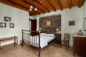 a bedroom with a bed and a brick wall at villa eirini in Kourélion