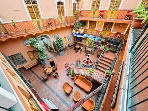 an overhead view of a courtyard of a building with tables and chairs at Hostal La Posada De La Abuela in La Paz