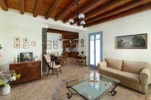 a living room with a couch and a table at villa eirini in Kourélion