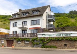 a large white house on top of a brick building at Moselgoldt in Burg