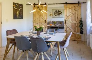 a dining room with a white table and chairs at Moselgoldt in Burg