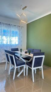a dining room with a white table and chairs at Green House Boca Chica in El Higo