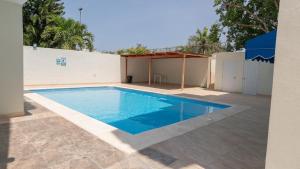 a swimming pool in a yard next to a building at Green House Boca Chica in El Higo