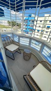 a balcony on a cruise ship with chairs and tables at Green House Boca Chica in El Higo