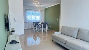 a living room with a couch and a table and chairs at Green House Boca Chica in El Higo