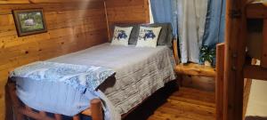 a small bedroom with a bed in a cabin at Texarkana KOA Journey in Texarkana