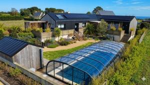 an aerial view of a house with a glass greenhouse at Les Suites du Littoral in Plouézec +10 photos
