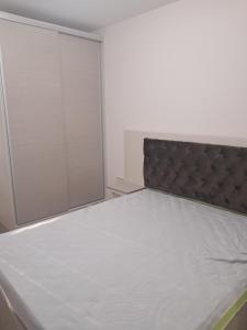 a bedroom with a bed and a mirror at Apartment Petrovi in Lovech