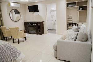 ein Wohnzimmer mit Sofa und Spiegel in der Unterkunft Hotel Arthemisa in Dolores Hidalgo