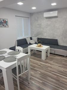 a living room with a couch and a table at Apartment Petrovi in Lovech