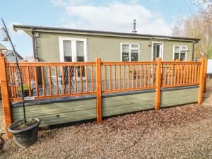 a wooden fence in front of a house at The Nest Lodge 55 in Grantham
