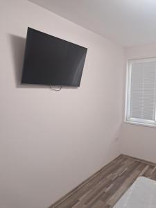 a flat screen tv hanging on a wall in a room at Apartment Petrovi in Lovech