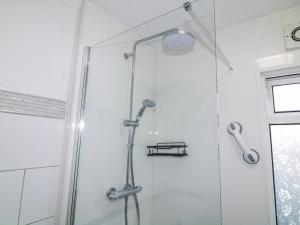 a shower with a glass door in a bathroom at The Nest Lodge 55 in Grantham +10 photos