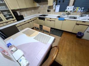a kitchen with a table and chairs and a sink at Japan Harry Potter 5min Walk Guesthouse 東京ハリーポッターまで徒歩5分の民宿 in Tokyo