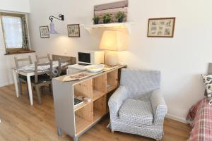 a room with a desk with a computer and a chair at Alla Cantina in Aurisina Case