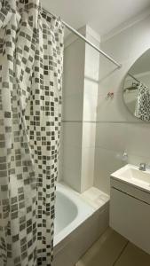 a bathroom with a shower curtain and a sink at PB-Súper dpto Morón centro in Morón +14 photos