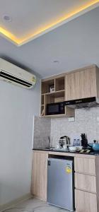 a kitchen with a sink and a refrigerator at Condo D-Eco Wellness Center A8721 in North Pattaya