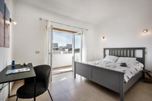 a bedroom with a bed and a desk and a window at Casa Jacadi Luxury Villa, Private Pool, Rooftop terrace with sea View! in Armação de Pêra +33 photos