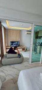 a woman laying on a bed in a bedroom at Condo D-Eco Wellness Center A8721 in North Pattaya +9 photos