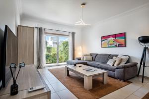 a living room with a couch and a table at Casa Jacadi Luxury Villa, Private Pool, Rooftop terrace with sea View! in Armação de Pêra