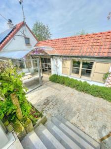 a house with a red roof and a patio at The River Cottage in Middelkerke +19 photos
