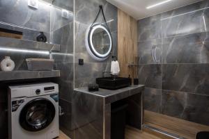 a bathroom with a sink and a washing machine at Casa Gemma 3 in Rhodes Town