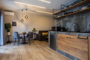 a kitchen and living room with a table and chairs at Casa Gemma 3 in Rhodes Town