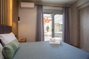 a bedroom with a bed with two folded towels on it at Casa Gemma 3 in Rhodes Town