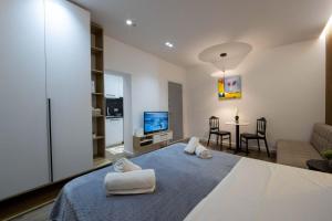 a bedroom with a large bed and a living room at Bliss Modern Retreat in Tirana