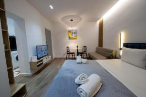 a bedroom with a bed and a living room at Bliss Modern Retreat in Tirana
