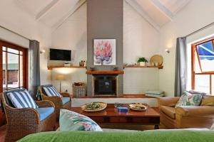 a living room with a couch and a fireplace at Stonehedge Cottages in Franschhoek