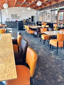 a dining room with tables and chairs and tablesktop at THE GOOD ONE Hotel Landshut in Landshut +23 photos