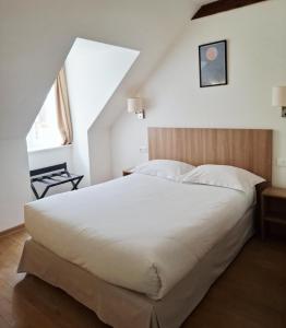 a bedroom with a large white bed and a window at Le Grand Hôtel Ussel ''nouvelle Gérance 2023'' in Ussel +29 photos