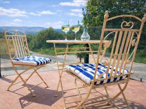 two chairs and a table with two glasses of wine at The Meetinka - Peaceful Stay, Jeseníky in Jeseník