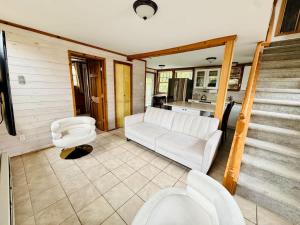 a living room with a couch and two chairs at Seabreeze #3 - Cozy cottage by the beach in Hampton Bays +12 photos