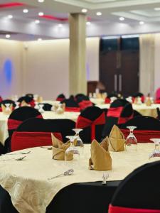 a dining room with tables and chairs with wine glasses at Hotel Divine Light Monaragala in Monaragala