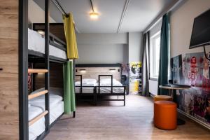 a hostel with bunk beds in a room at a&o Brussel Centrum in Brussels